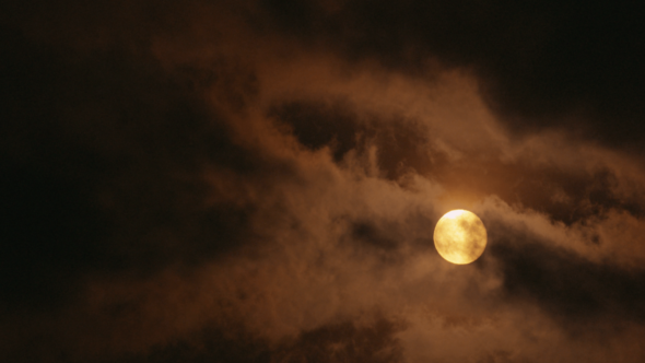 Full Moon Shining Through Clouds